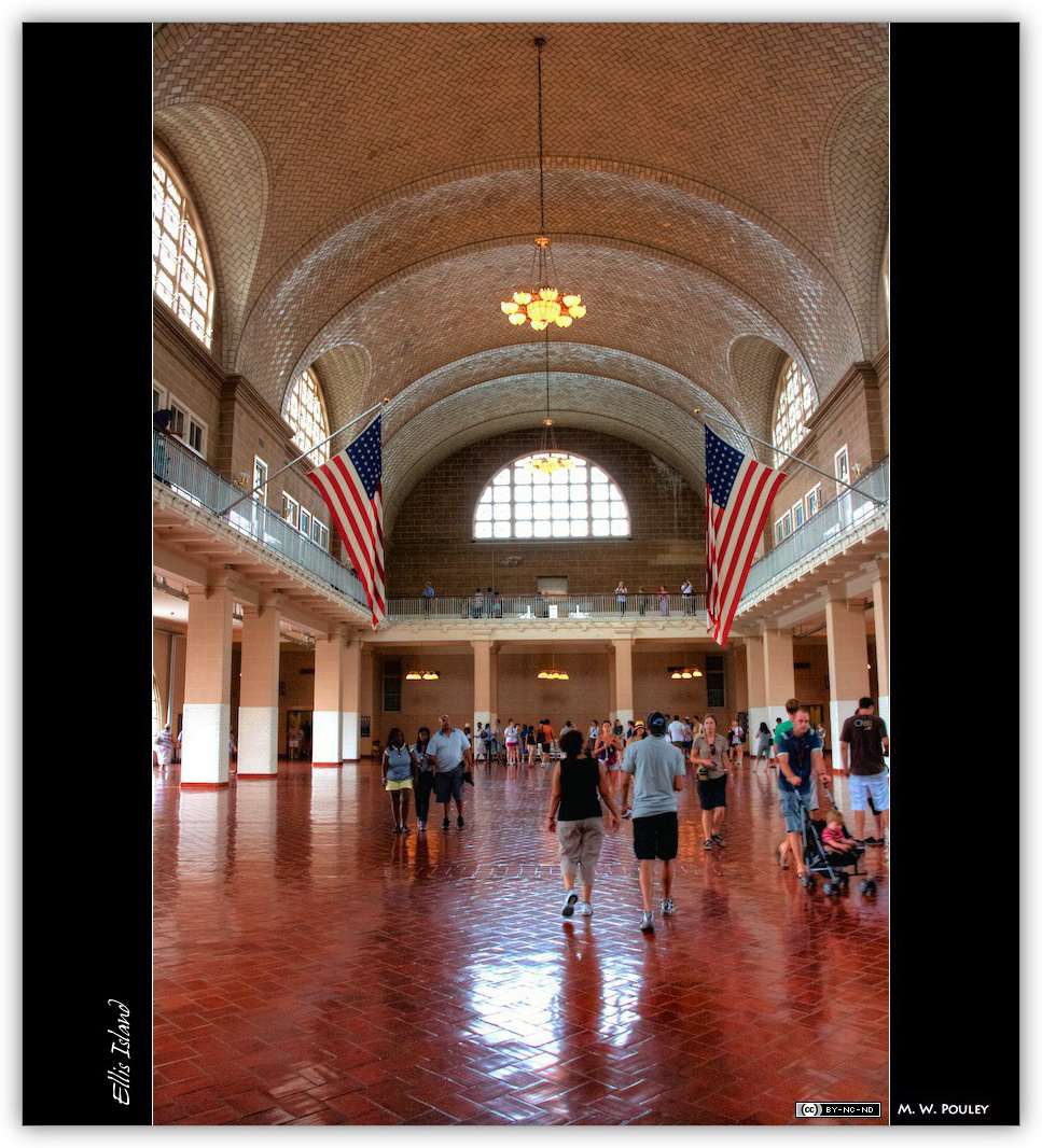 The great hall at ellis island, polished red brick floor and arching ceiling. 